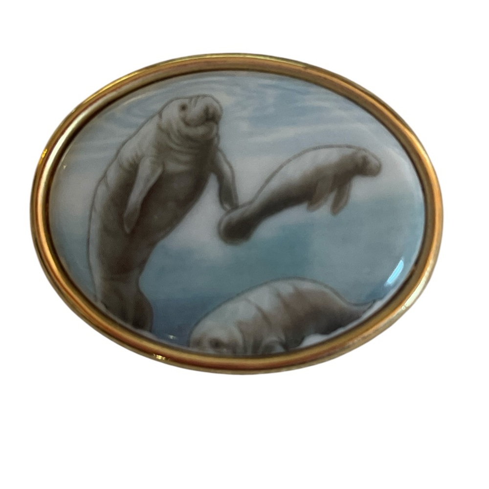 Elegant Manatee Brooch with Gold Trim